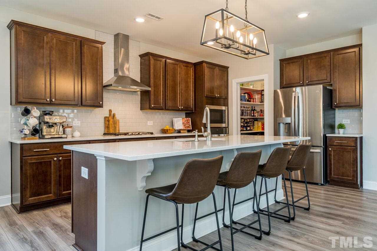 5220 Beckom Street Raleigh, NC 27616 - Photo 12 of 30 The contrast of dark cabinets and light counters is very impressive.