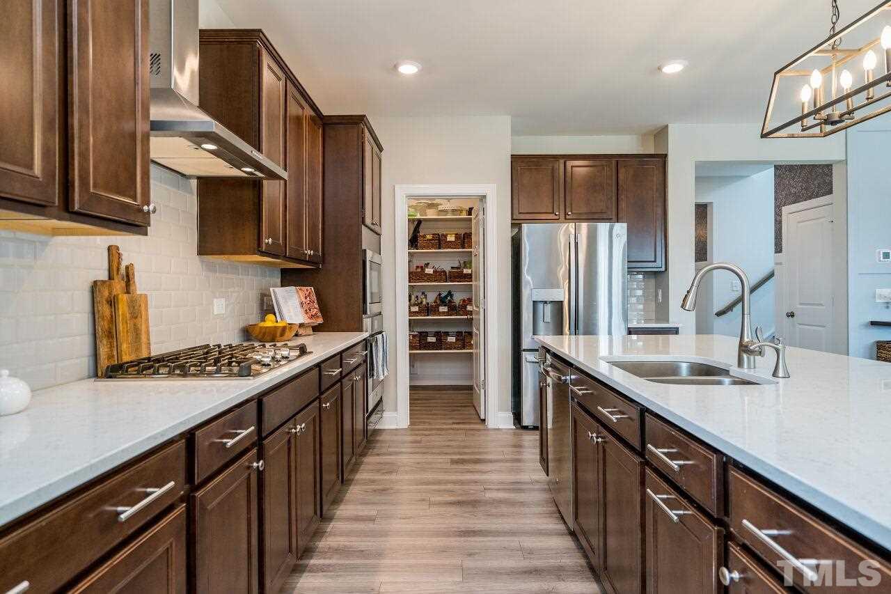 5220 Beckom Street Raleigh, NC 27616 - Photo 13 of 30 There is abundant cabinet and counter space in this well-designed kitchen.