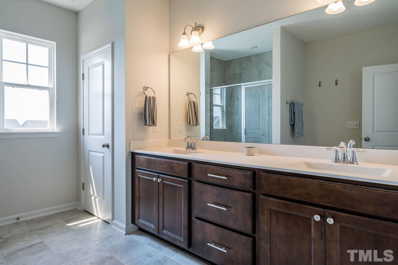 5220 Beckom Street Raleigh, NC 27616 - Photo 19 of 30 This is the perfect escape at the end of the day! The master bathroom has tile floors and a dual vanity.
