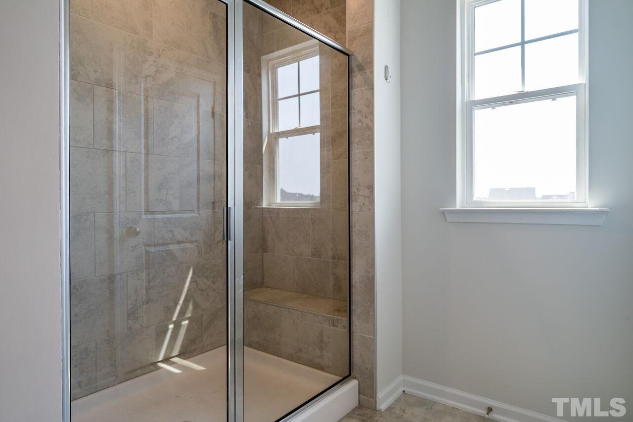 5220 Beckom Street Raleigh, NC 27616 - Photo 20 of 30 The beautiful tile shower adds charm and character.