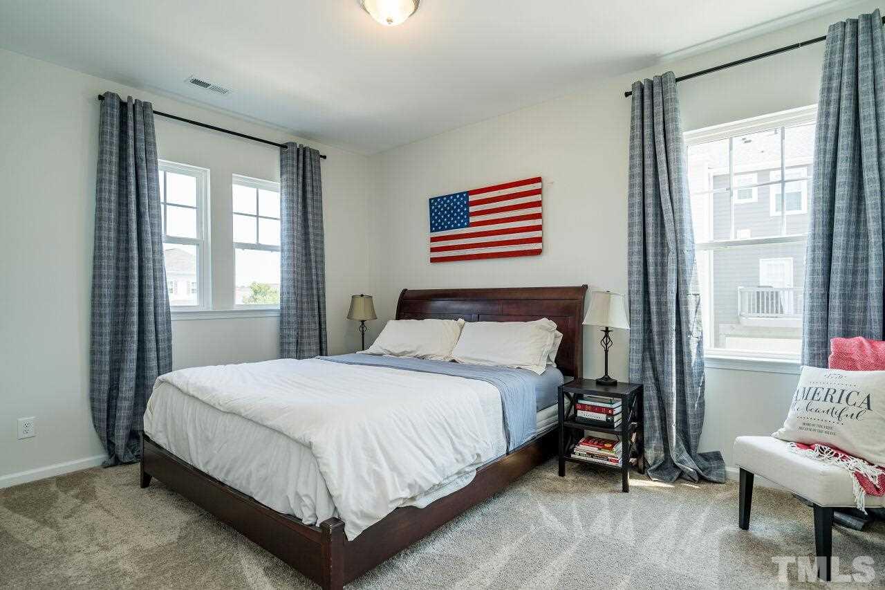 5220 Beckom Street Raleigh, NC 27616 - Photo 23 of 30 Two secondary bedrooms are located on the upper level. All have nicely-sized closets.