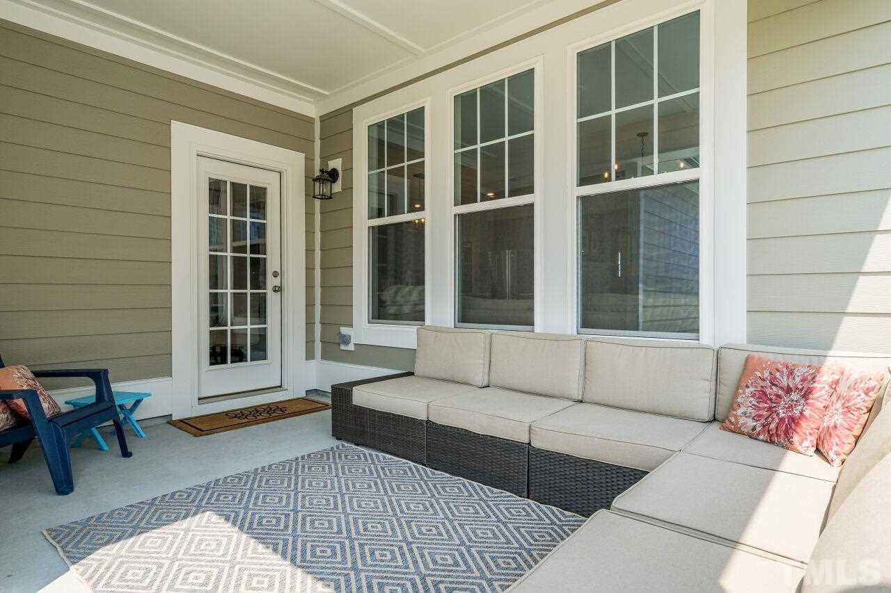 5220 Beckom Street Raleigh, NC 27616 - Photo 27 of 30 The covered patio is spacious enough for comfortable furniture and it's a great space to relax.