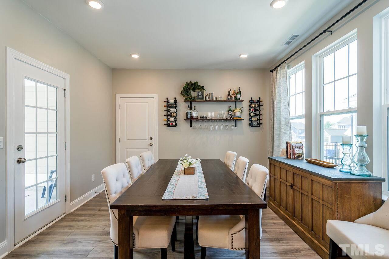 5220 Beckom Street Raleigh, NC 27616 - Photo 9 of 30 In addition to counter seating in the kitchen, there can be overflow in the dining area.