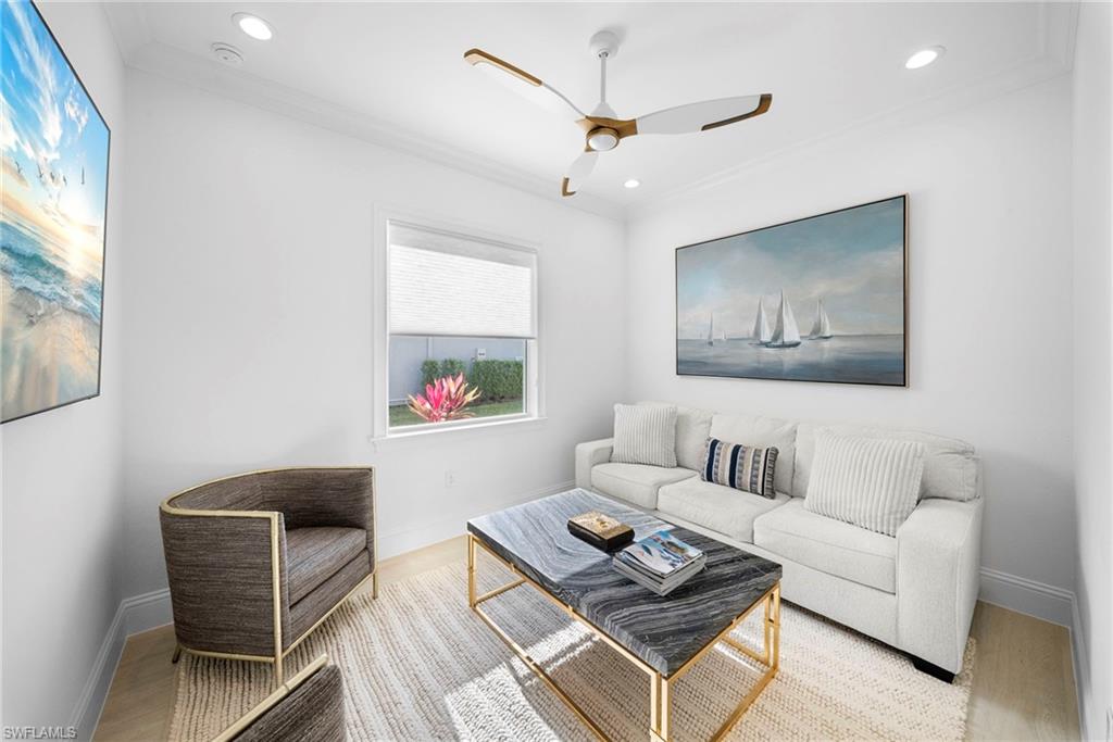 8923 Gustavia Court Naples, FL 34113 - Photo 14 of 50 a living room with furniture and a painting on the wall