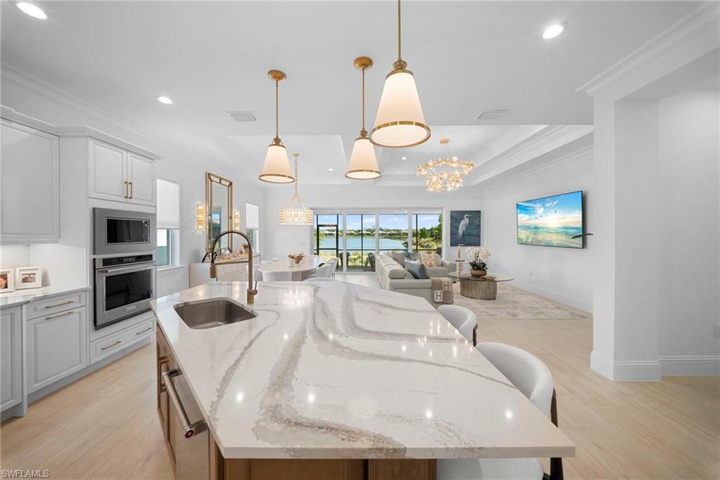 8923 Gustavia Court Naples, FL 34113 - Photo 20 of 50 a kitchen with stainless steel appliances granite countertop a sink a stove and a refrigerator