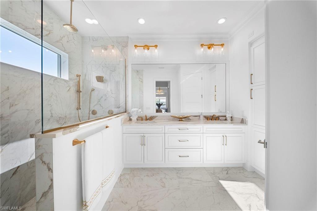 8923 Gustavia Court Naples, FL 34113 - Photo 26 of 50 a bathroom with a sink vanity and mirror