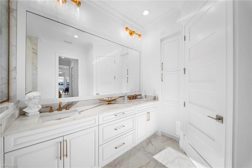8923 Gustavia Court Naples, FL 34113 - Photo 27 of 50 a bathroom with a sink and a mirror
