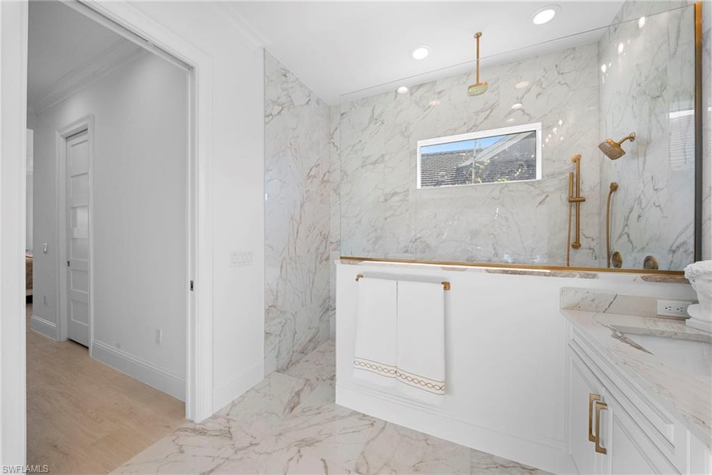 8923 Gustavia Court Naples, FL 34113 - Photo 28 of 50 a bathroom with a sink and a mirror