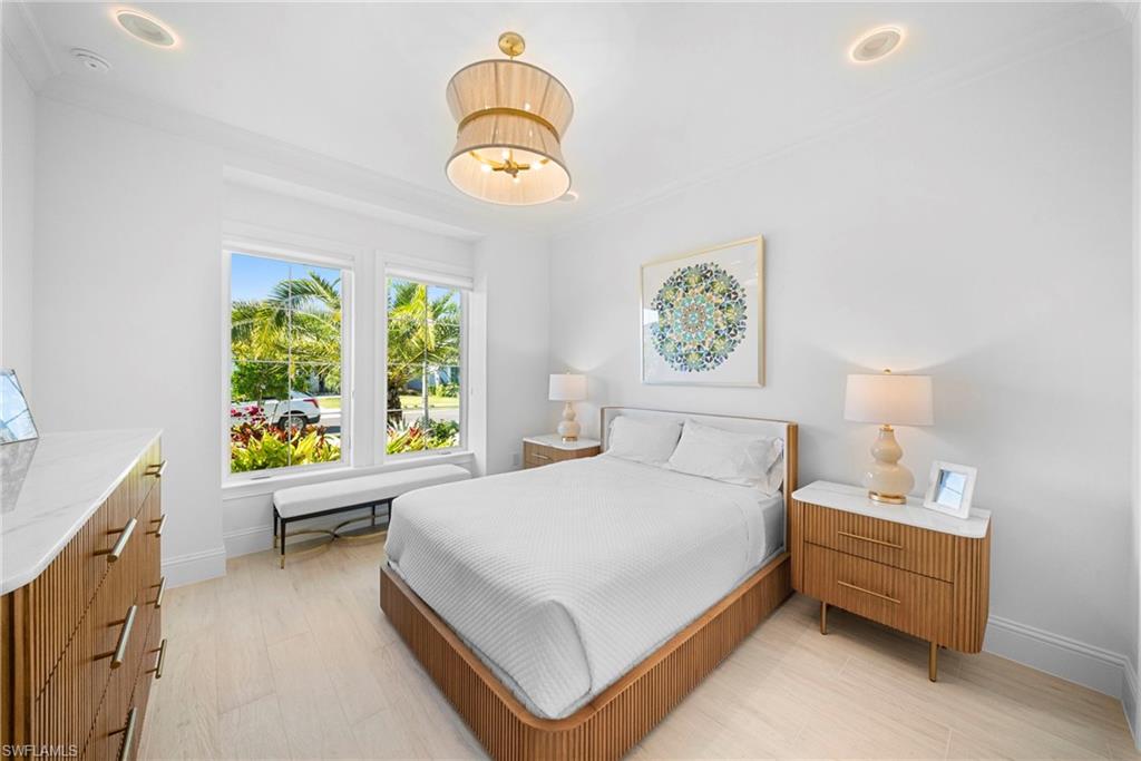 8923 Gustavia Court Naples, FL 34113 - Photo 31 of 50 a bedroom with a bed and a window