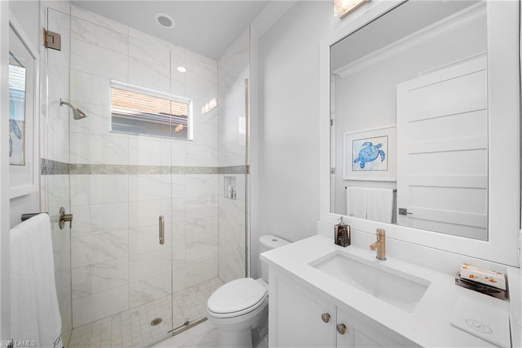 8923 Gustavia Court Naples, FL 34113 - Photo 32 of 50 a bathroom with a sink toilet and shower