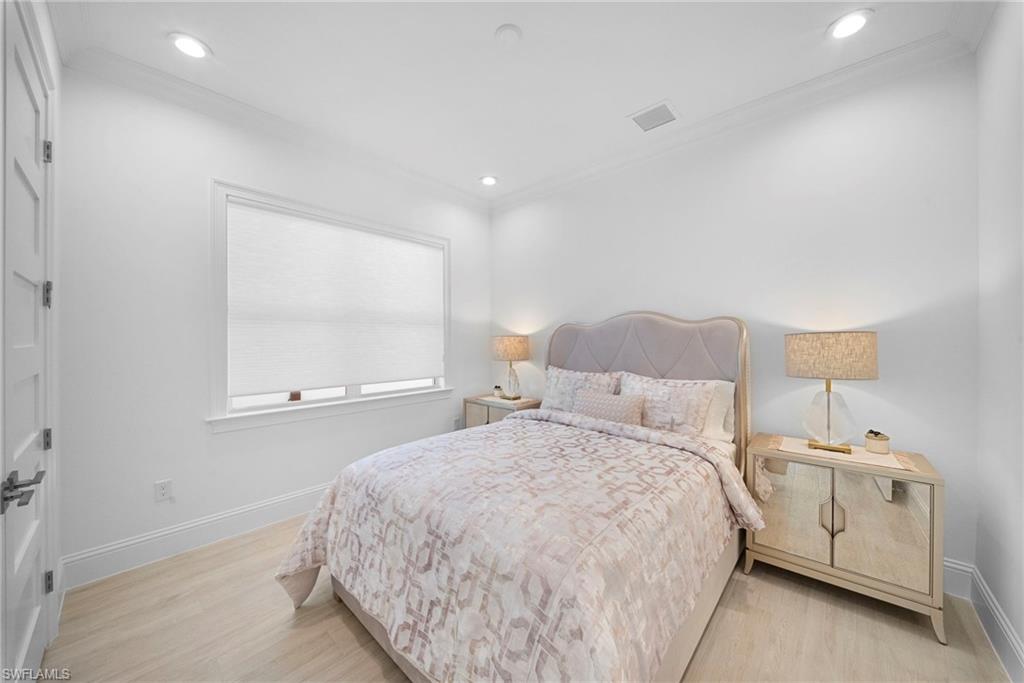 8923 Gustavia Court Naples, FL 34113 - Photo 33 of 50 a bedroom with a bed and a night stand