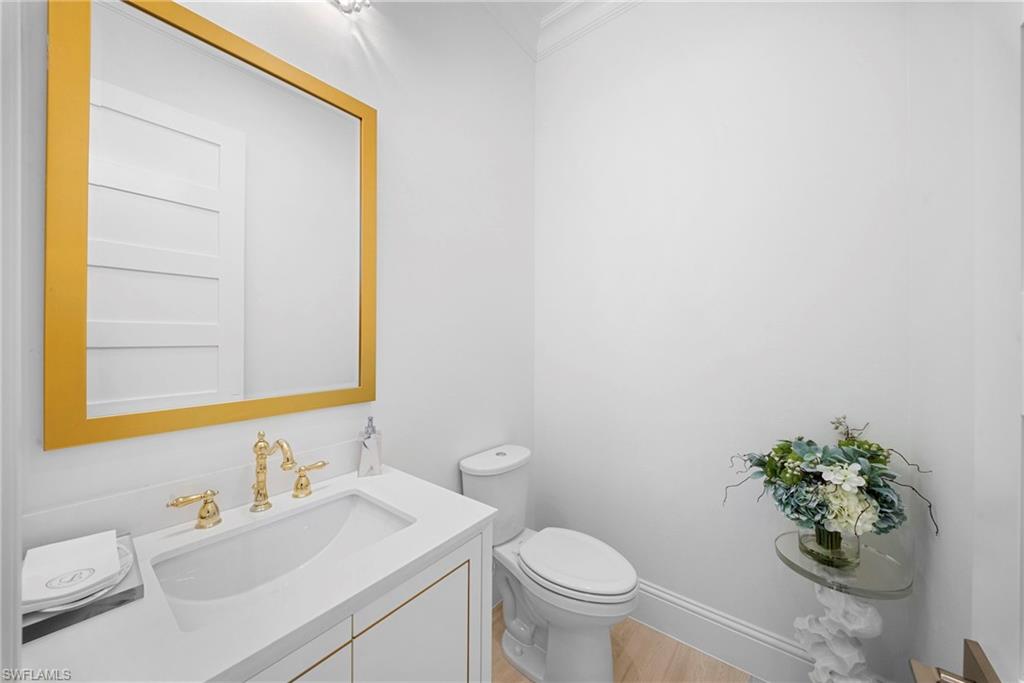 8923 Gustavia Court Naples, FL 34113 - Photo 34 of 50 a bathroom with a sink toilet and mirror