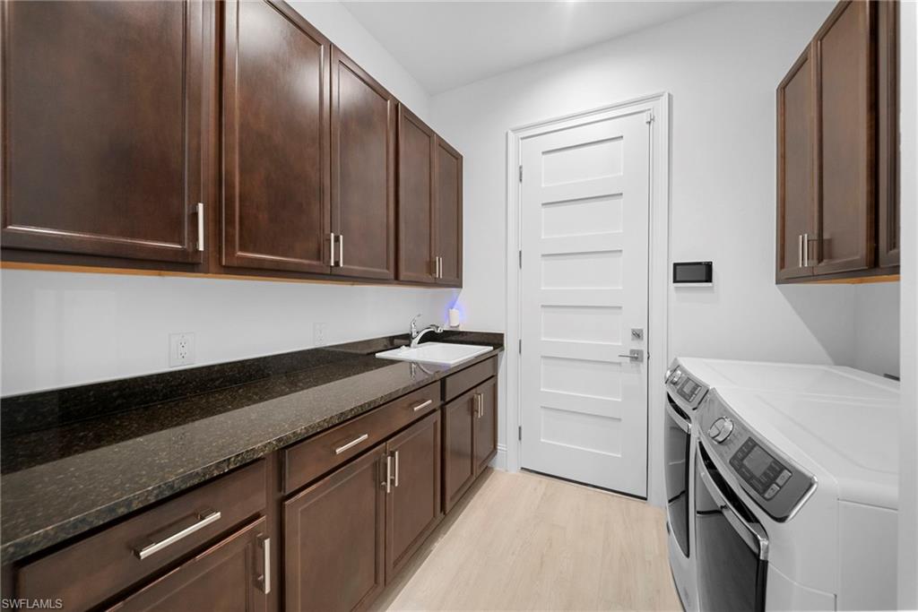 8923 Gustavia Court Naples, FL 34113 - Photo 36 of 50 a kitchen with a sink and cabinets