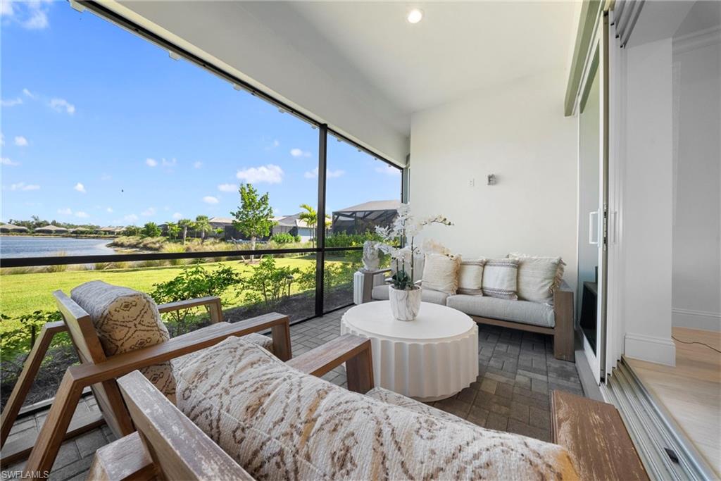 8923 Gustavia Court Naples, FL 34113 - Photo 38 of 50 a balcony with couch and city view