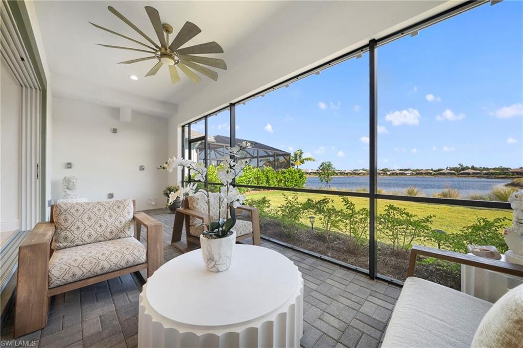8923 Gustavia Court Naples, FL 34113 - Photo 40 of 50 a living room with furniture and a floor to ceiling window