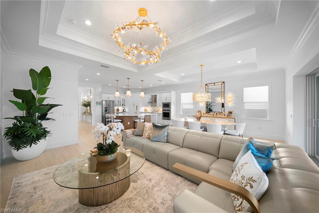 8923 Gustavia Court Naples, FL 34113 - Photo 4 of 50 a living room with furniture and a chandelier