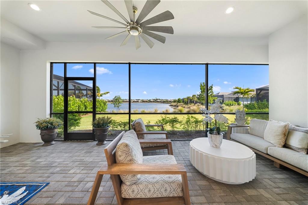 8923 Gustavia Court Naples, FL 34113 - Photo 41 of 50 a living room with patio furniture and a floor to ceiling window