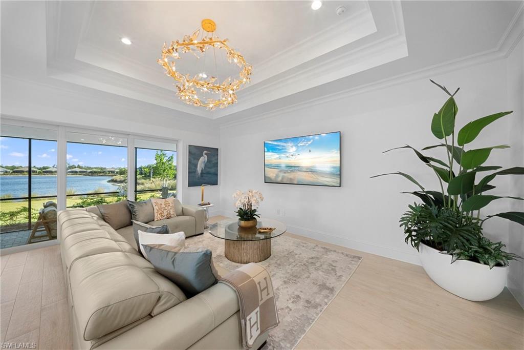 8923 Gustavia Court Naples, FL 34113 - Photo 5 of 50 a living room with furniture potted plant and a large window