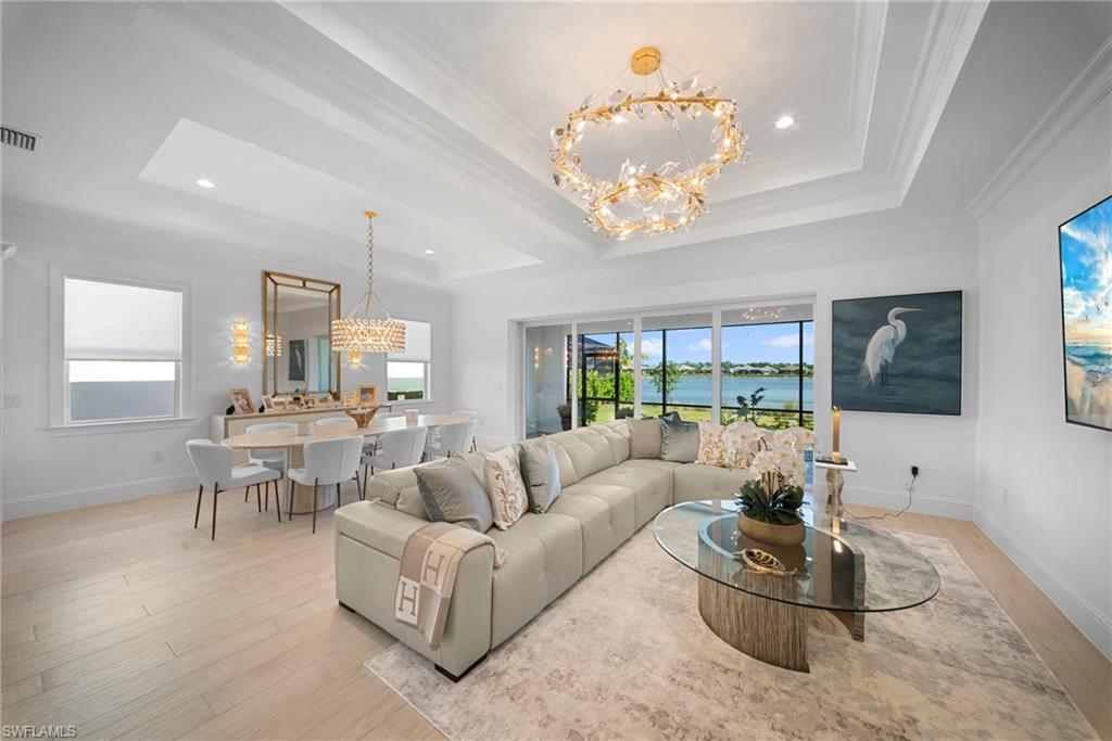 8923 Gustavia Court Naples, FL 34113 - Photo 6 of 50 a living room with furniture chandelier and a large window