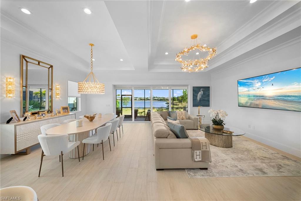 8923 Gustavia Court Naples, FL 34113 - Photo 7 of 50 a living room with furniture and a chandelier