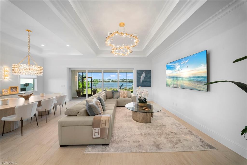 8923 Gustavia Court Naples, FL 34113 - Photo 8 of 50 a living room with furniture chandelier and a window