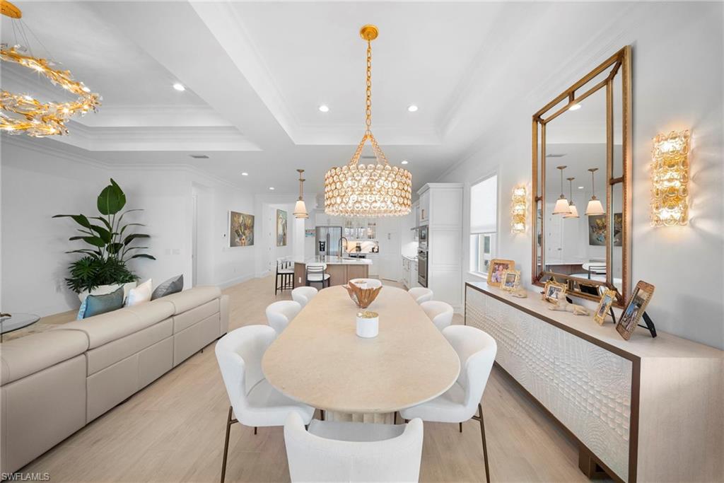 8923 Gustavia Court Naples, FL 34113 - Photo 10 of 50 a view of a dining room with furniture and a chandelier
