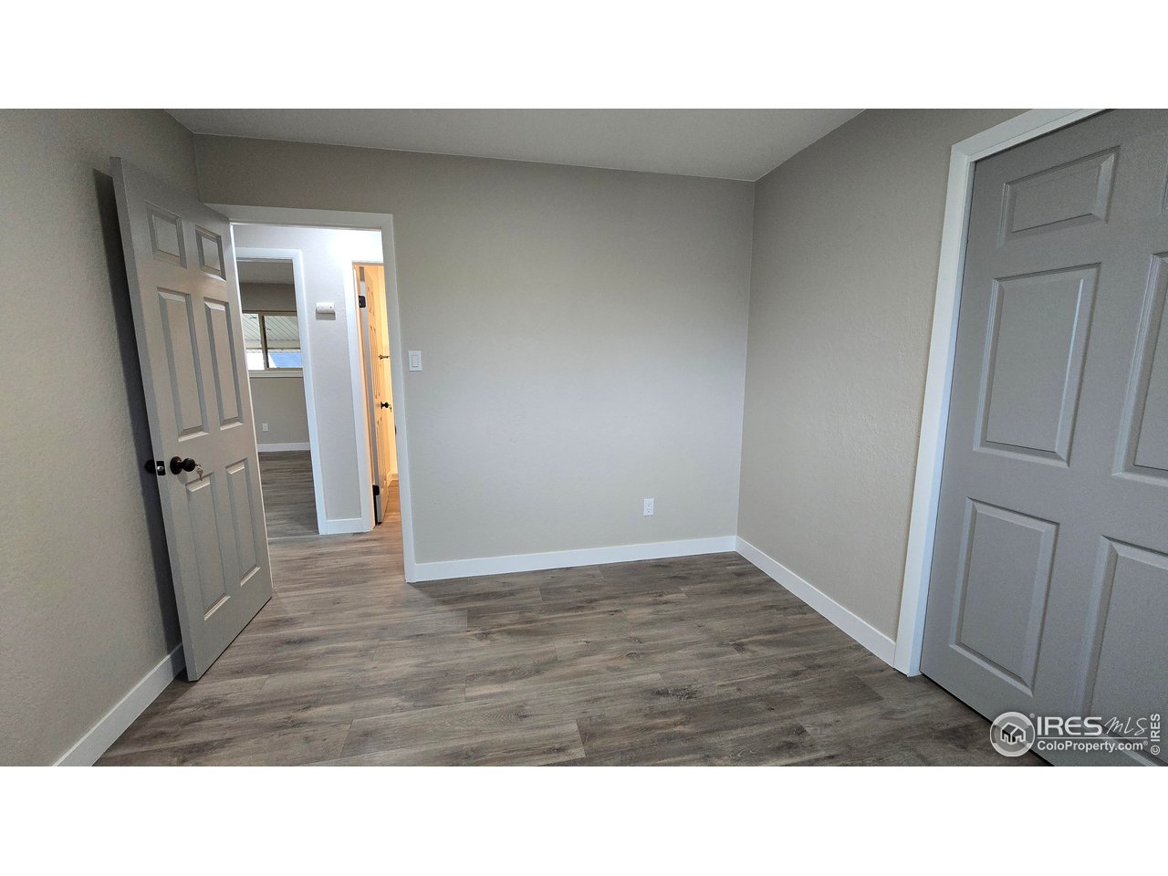 1312 Coolidge Street Sterling, CO 80751 - Photo 21 of 37 BEDROOM ONE WITH VIEW TO HALLWAY WITH BATHROOM ACROSS TO THE RIGHT AND PRIMARY BEDROOM TO THE LEFT