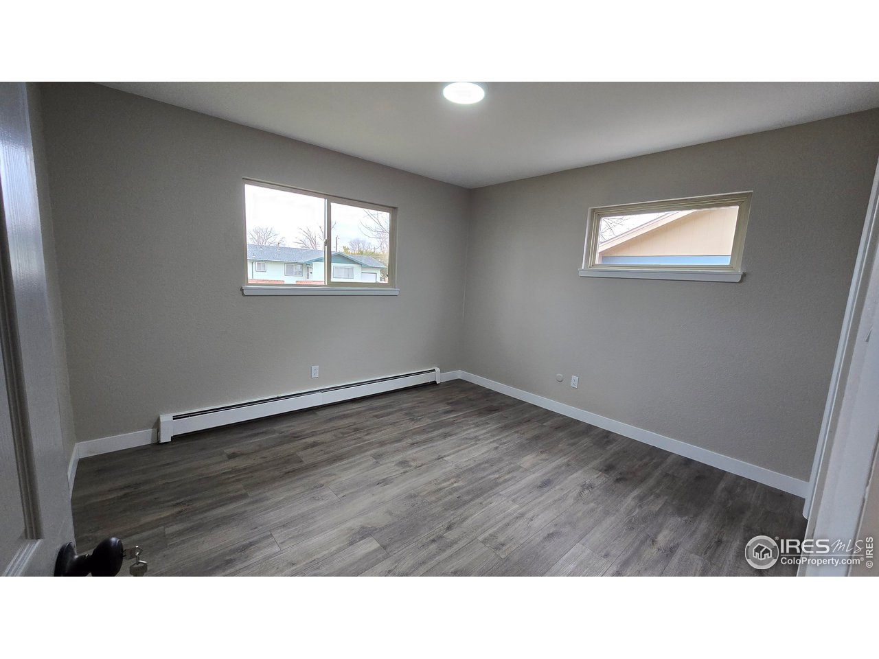 1312 Coolidge Street Sterling, CO 80751 - Photo 22 of 37 SECOND BEDROOM FROM HALLWAY, WINDOW AT THE LEFT FACES STREET, WINDOW TO THE RIGHT FACES THE SIDE OF HOME, NORTH SIDE