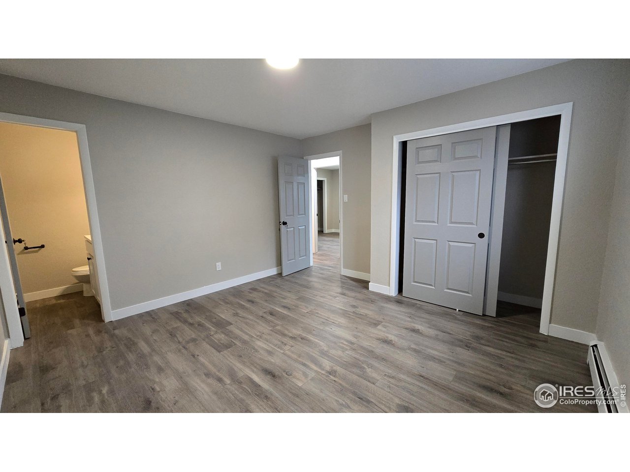 1312 Coolidge Street Sterling, CO 80751 - Photo 25 of 37 PRIMARY BEDROOM LOOKING TOWARDS THE HALLWAY. LARGE CLOSET TO THE RIGHT AND HALF BATH ON THE FAR LEFT.