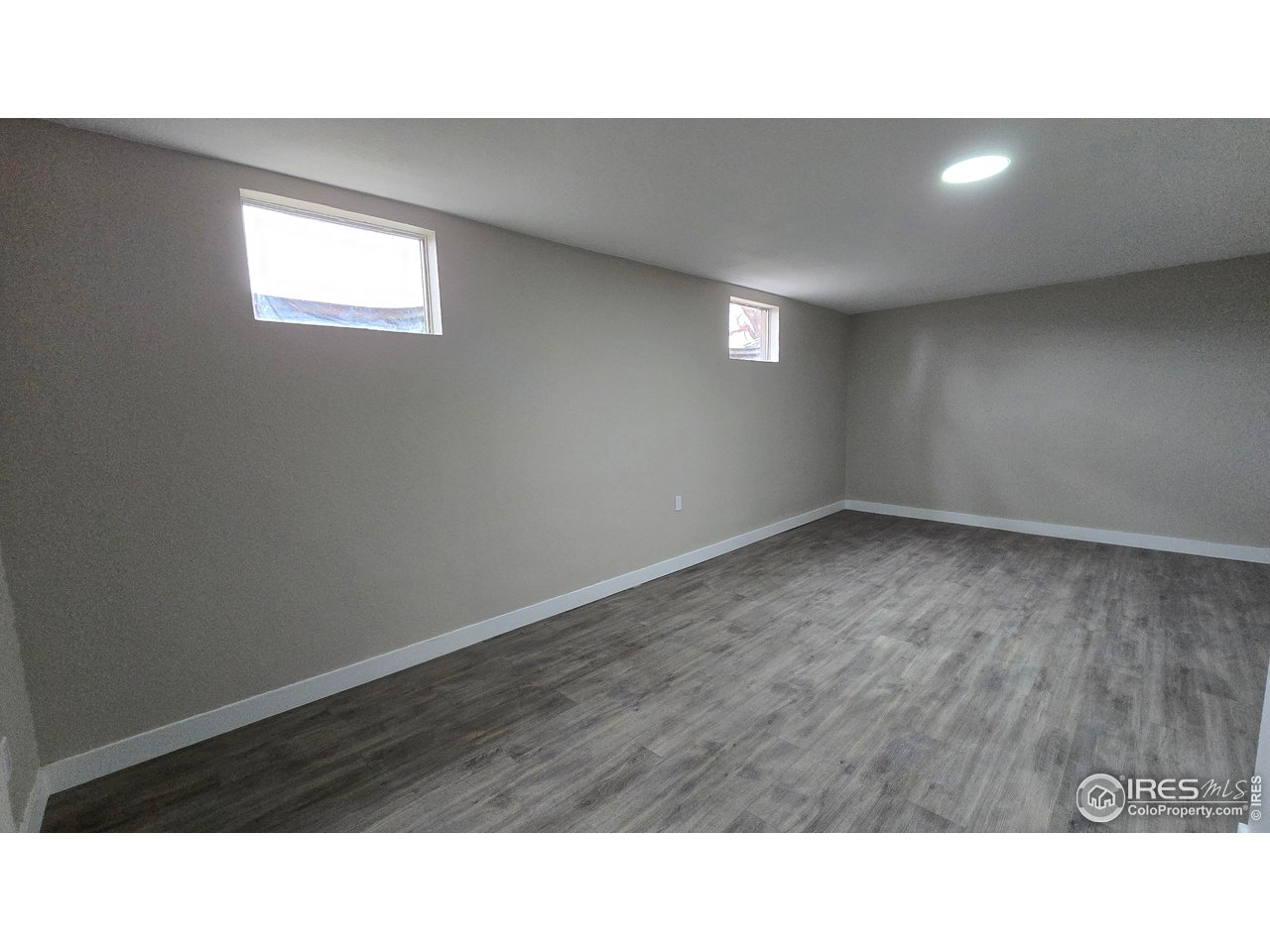 1312 Coolidge Street Sterling, CO 80751 - Photo 31 of 37 LARGE BASEMENT BEDROOM FROM THE HALLWAY. WINDOWS FACE THE STREET