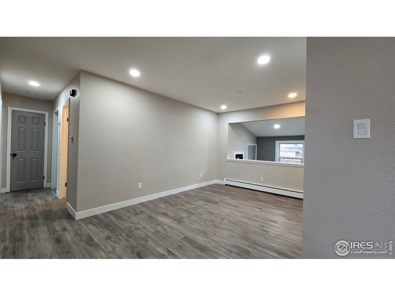 1312 Coolidge Street Sterling, CO 80751 - Photo 6 of 37 DINING ROOM FROM TOP OF STAIRS TO BASEMENT. VIEW OF FAMILY ROOM PAST DINING ROOM THAT FACES BACK YARD. 3/4 BATH TO THE LEFT WITH THE BRIGHT LIGHT COMING FROM THE ROOM
