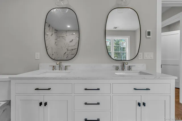 a bathroom with mirror and sink
