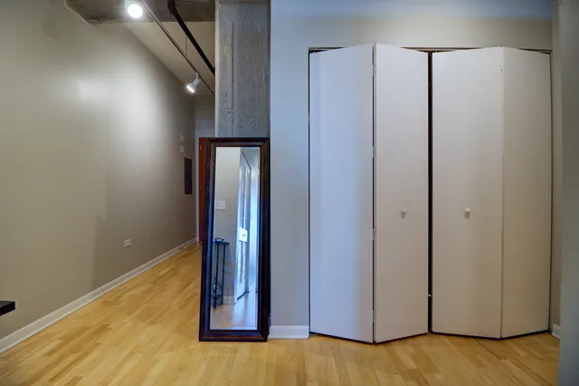 a bedroom with a bed and a desk