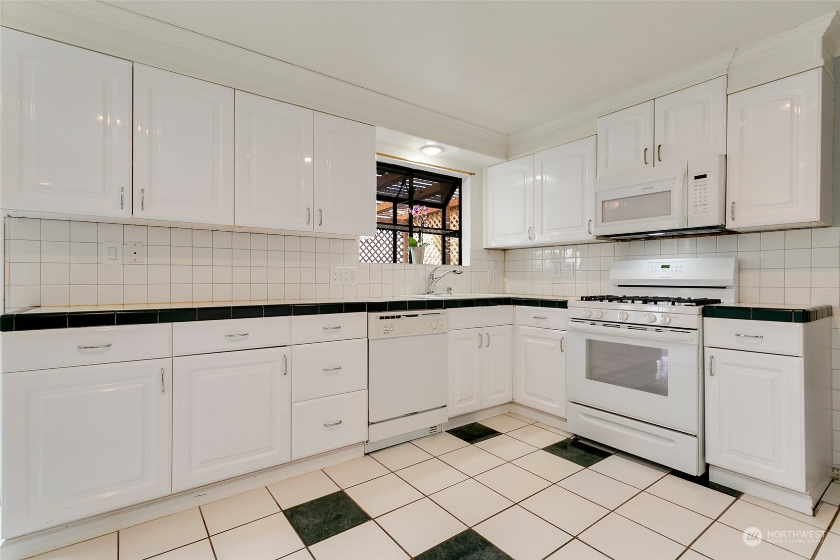 965 Hoquiam Avenue Northeast Renton, WA 98059 - Photo 11 of 37 a kitchen with granite countertop white cabinets and white appliances