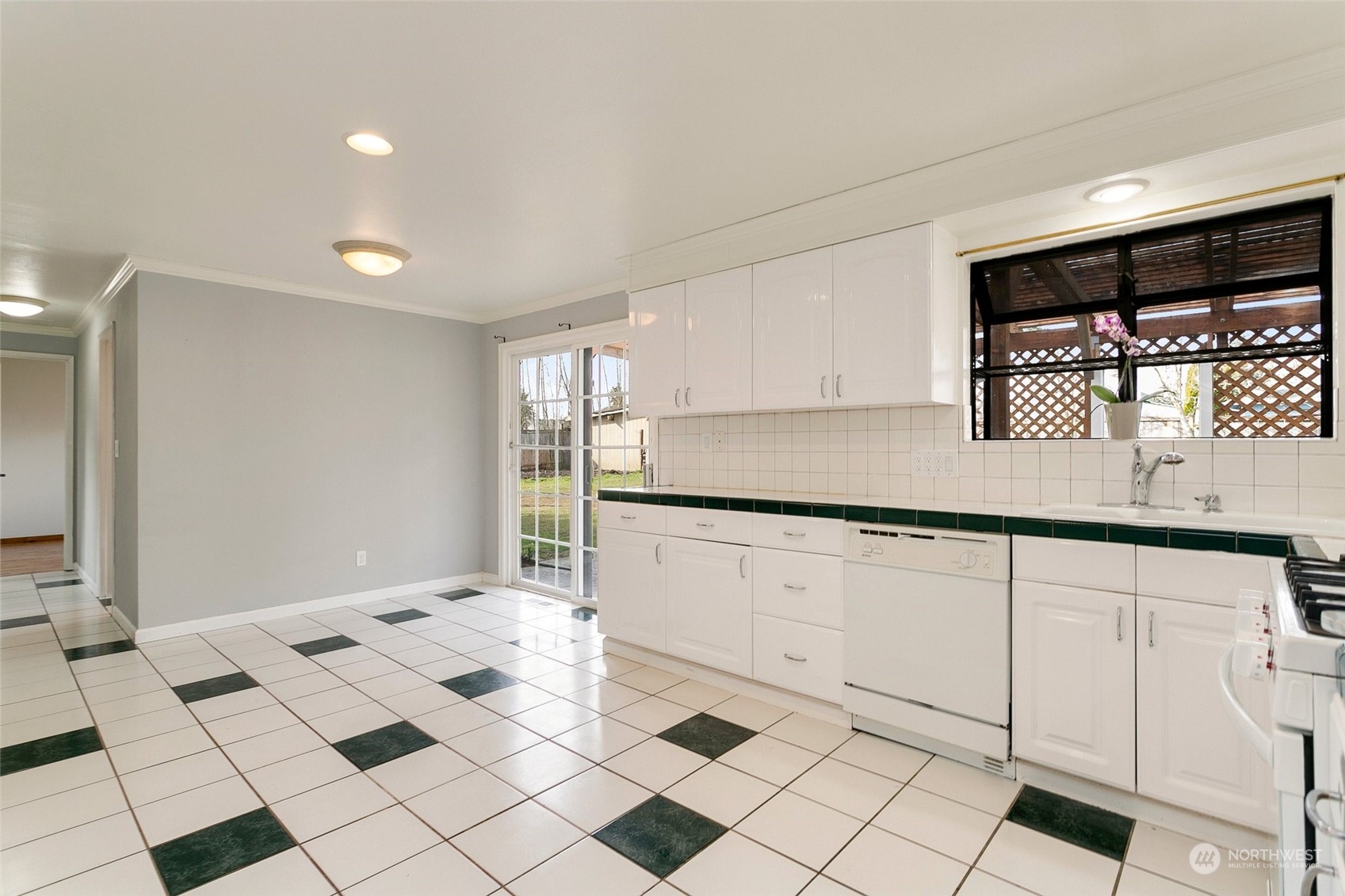 965 Hoquiam Avenue Northeast Renton, WA 98059 - Photo 13 of 37 a kitchen with granite countertop white cabinets and white appliances