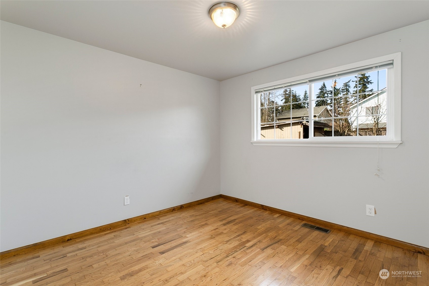 965 Hoquiam Avenue Northeast Renton, WA 98059 - Photo 22 of 37 a view of empty room with wooden floor and fan