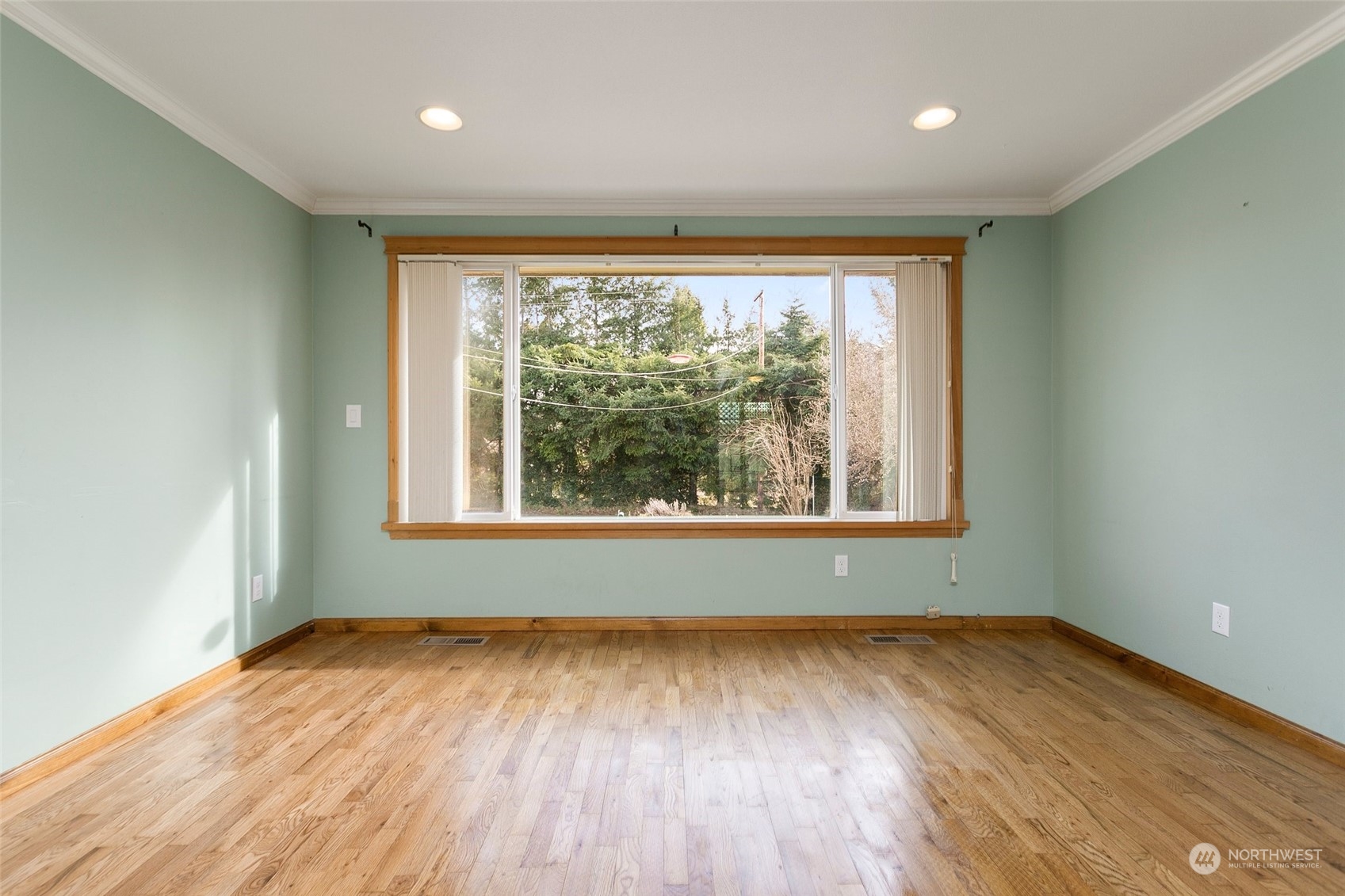 965 Hoquiam Avenue Northeast Renton, WA 98059 - Photo 6 of 37 an empty room with wooden floor and windows