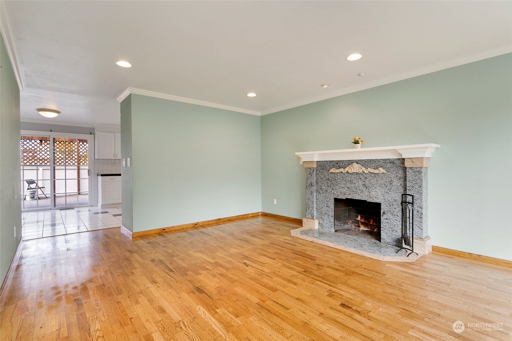 965 Hoquiam Avenue Northeast Renton, WA 98059 - Photo 7 of 37 a view of an empty room with wooden floor and a fireplace