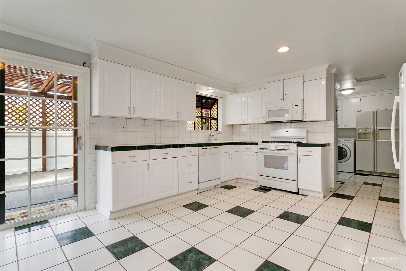 965 Hoquiam Avenue Northeast Renton, WA 98059 - Photo 8 of 37 a kitchen with a stove a sink and a refrigerator