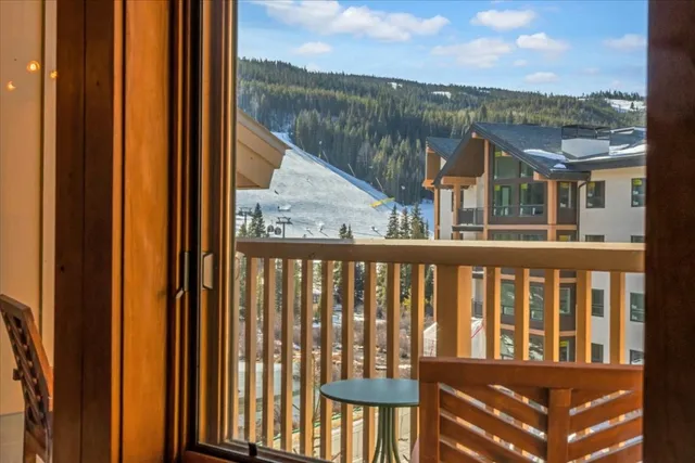 a view of a chairs and table in the balcony