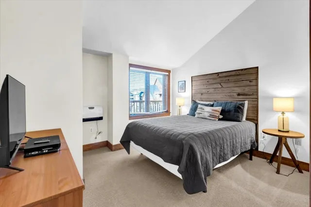 a bedroom with a bed and dresser