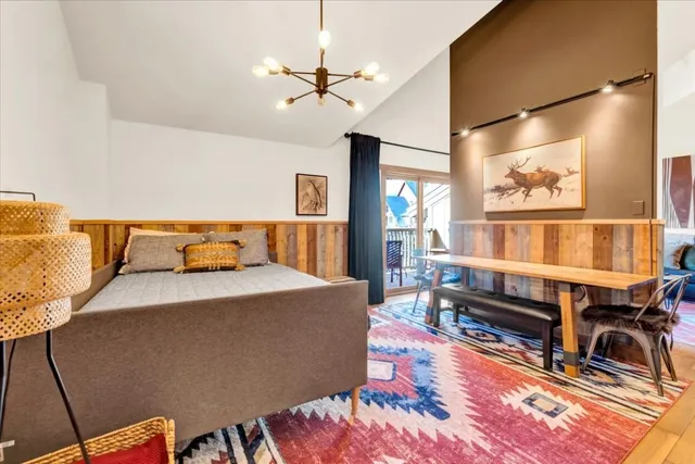 a living room with furniture a rug and a chandelier