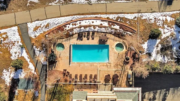 a room with furniture pool table flat screen tv and view of kitchen