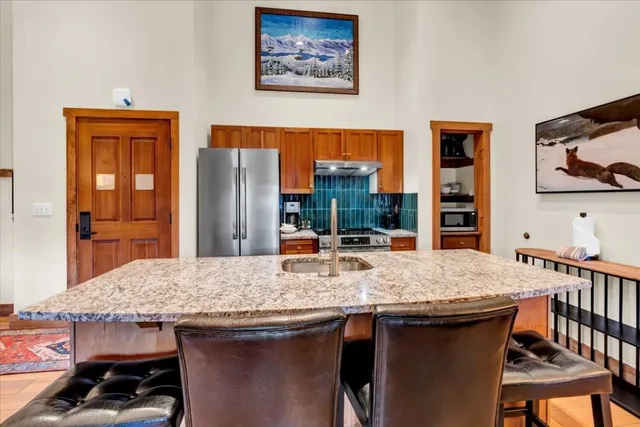 a view of a dining room with furniture and a kitchen