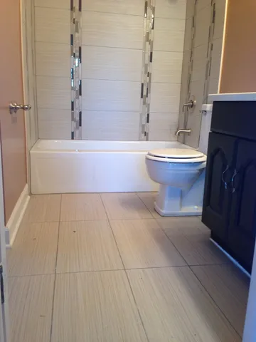a bathroom with a bathtub and sink