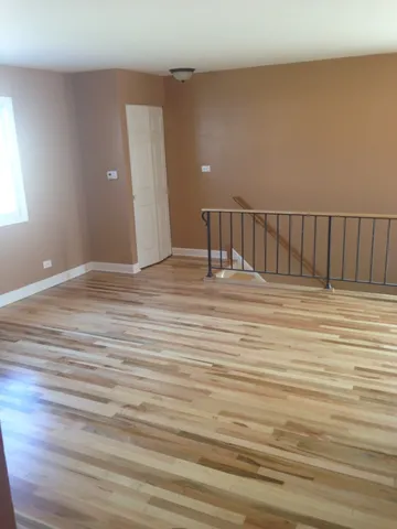 a view of wooden floor and windows in a room