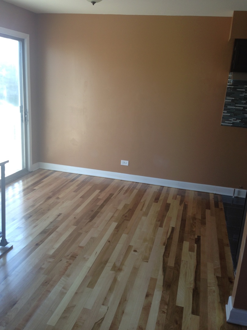 157 Peter Court, Unit D Bartlett, IL 60103 - Photo 3 of 16 a view of a room with wooden floor and a window