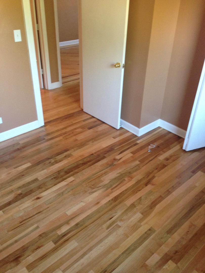 157 Peter Court, Unit D Bartlett, IL 60103 - Photo 9 of 16 a view of a room with wooden floor and staircase