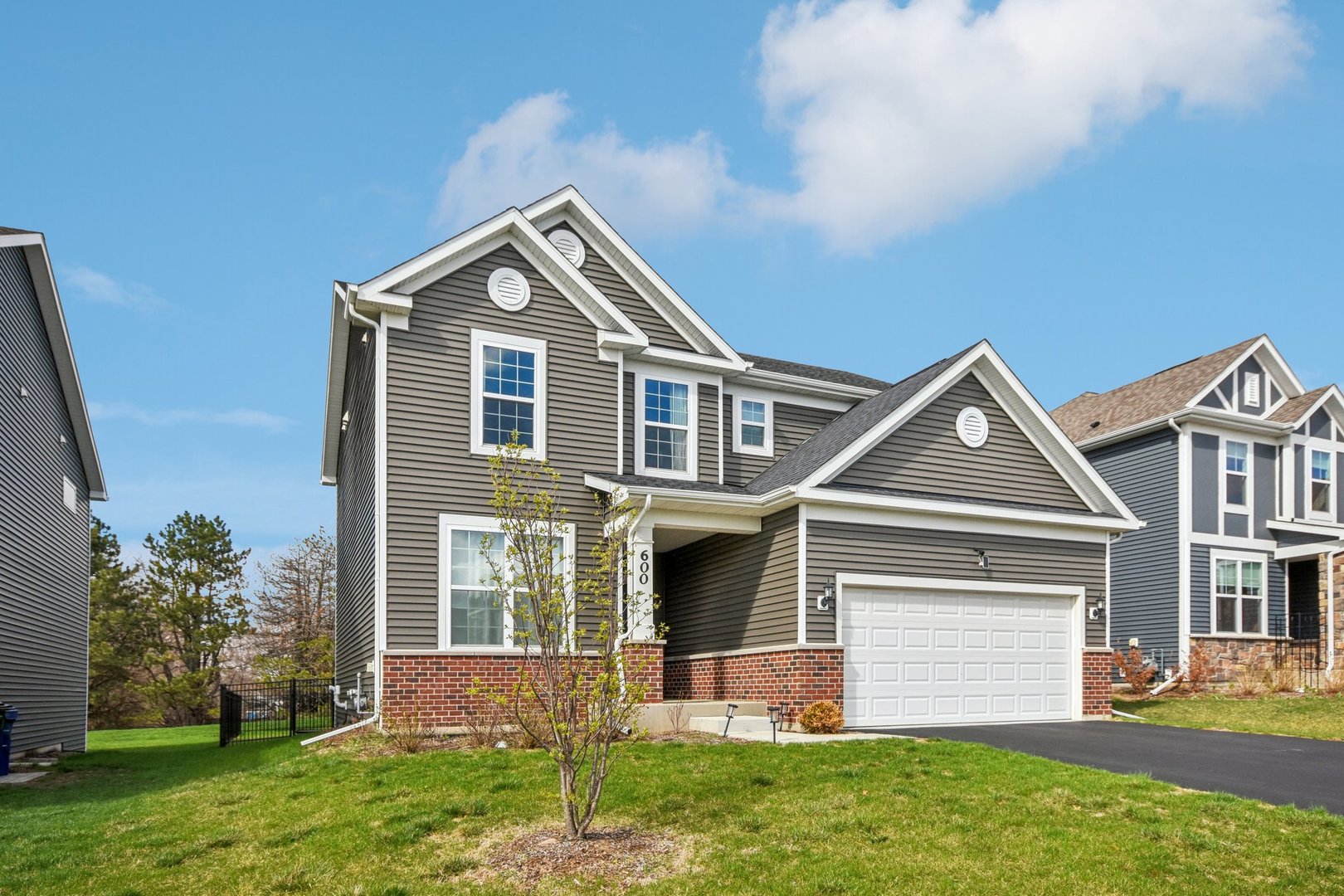 600 Alpine Drive Algonquin, IL 60102 - Photo 2 of 40 a front view of a house with a yard and garage