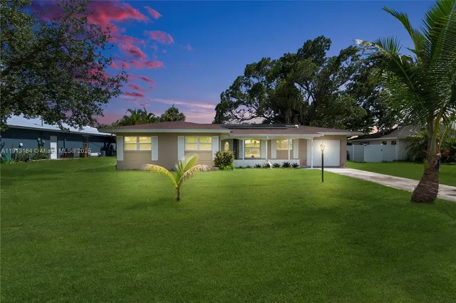 a front view of a house with a garden